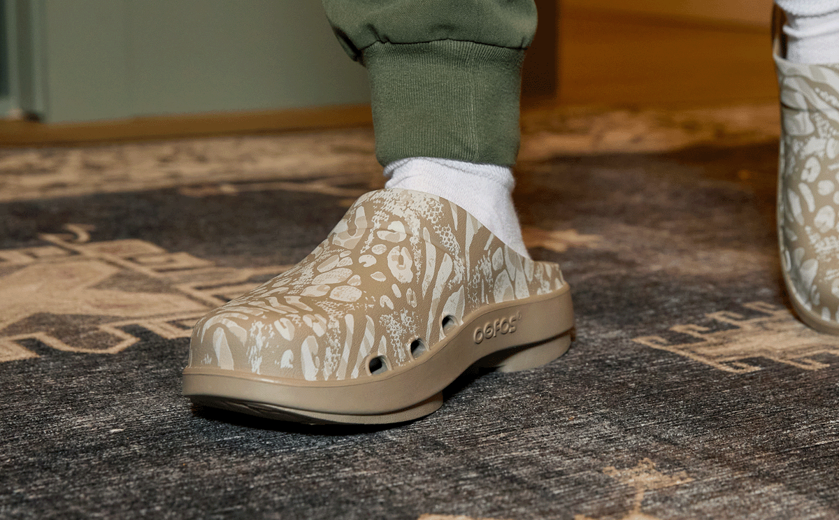 Women's OOcloog Limited Edition Clog - Nomad Combo Camo close up of shoe on model standing on rug | lifestyle
