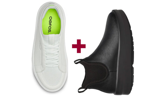 White sneaker with green logo and black shoe sole on a white background
