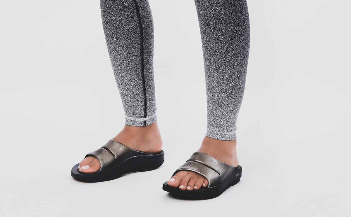 Women's OOahh Luxe Slide Sandal - Latte model standing in studio | lifestyle
