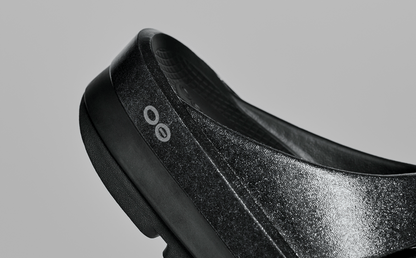 Women's OOmega OOahh Stacked Sandal - Black Sparkle close up of shoe in studio | lifestyle