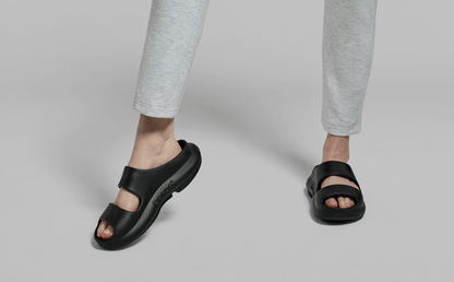 Women's OOyea Slide Sandal - Black front view of model standing in studio | lifestyle
