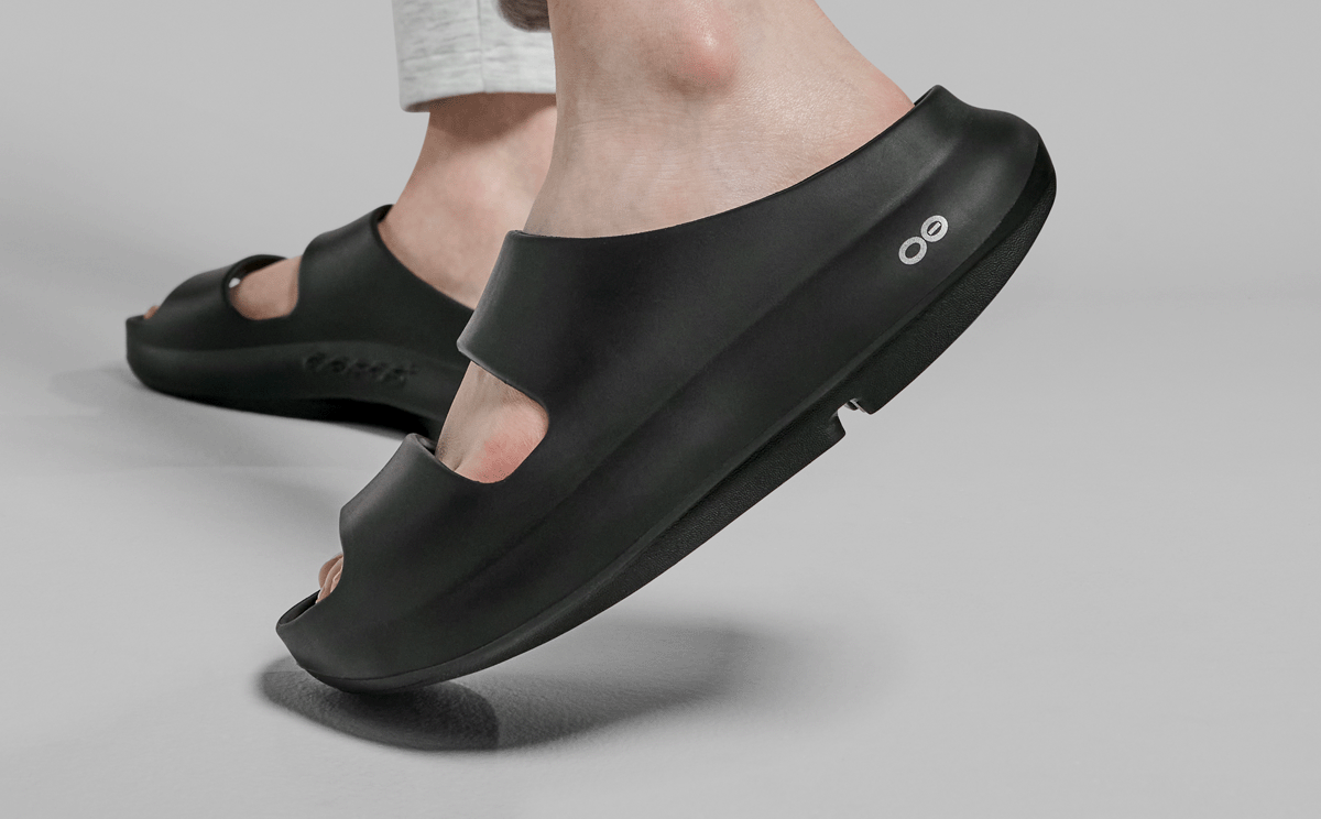 Women's OOyea Slide Sandal - Black close up side view of shoe on model | lifestyle