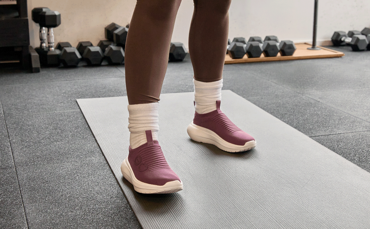 Women's OOmy Zen - Mulberry model standing on workout mat in gym | lifestyle