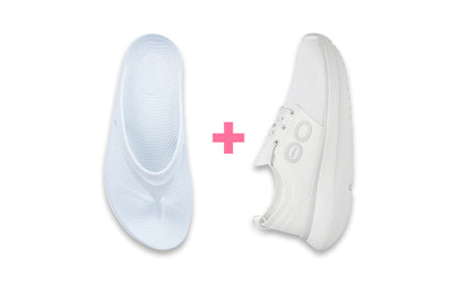 White sneakers with a pink plus sign between them on a white background