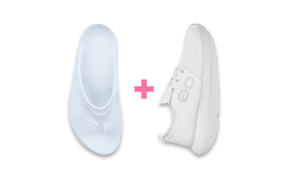 White sneakers with a pink plus sign between them on a white background