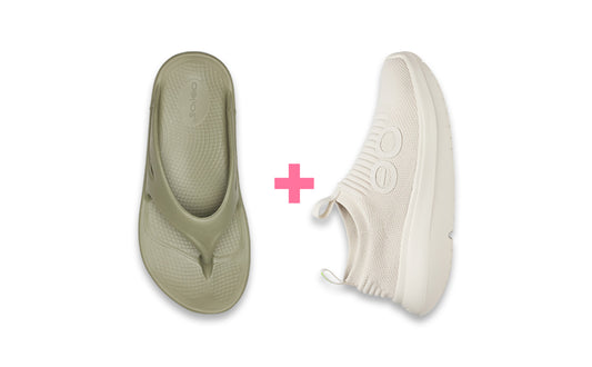 Pair of green flip-flops and white sneakers on a white background