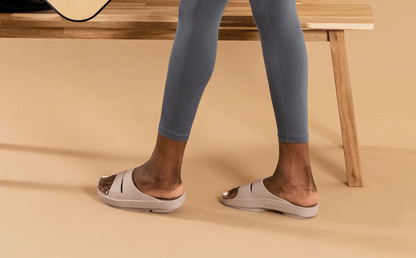 Women's OOahh Slide Sandal - Nomad model standing in studio with tan backgound | lifestyle