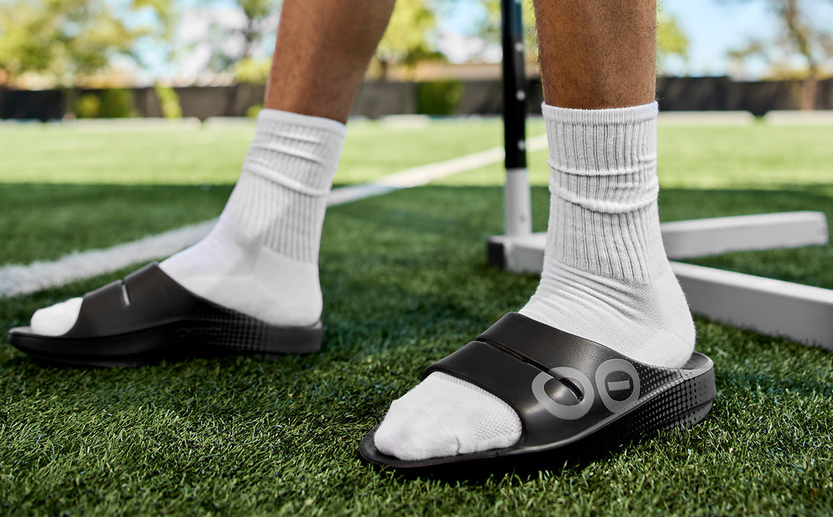 Men's OOahh Sport Slide Sandal - Black Matrix model standing outside in field | lifestyle