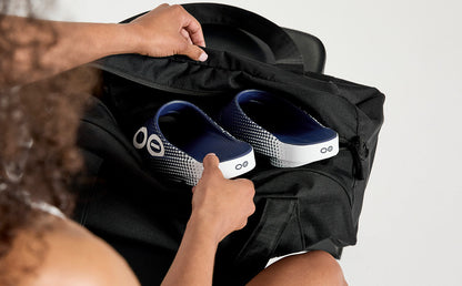Women's OOahh Sport Slide Sandal - Navy Matrix model putting shoes into gym bag | lifestyle