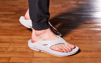 Person wearing a moonstone sandal on a wooden floor | lifestyle