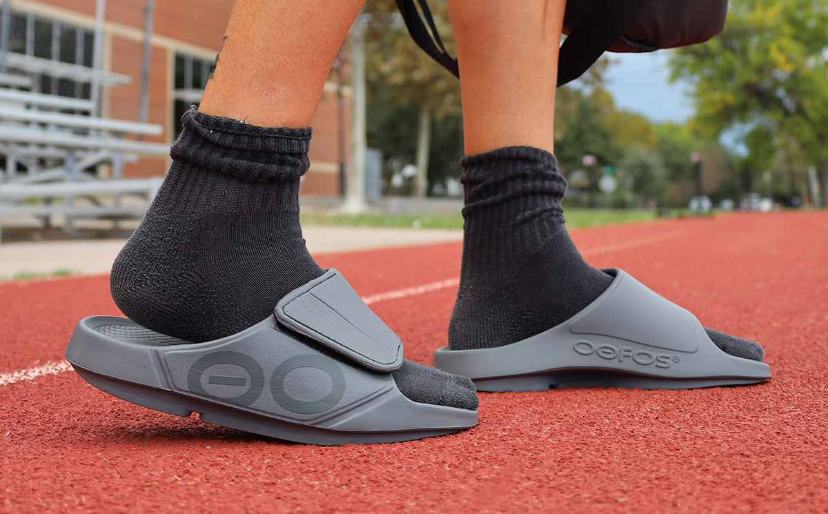 Men's OOahh Sport Flex Sandal - Slate lifestyle image of model in shoes walking on a track| lifestyle