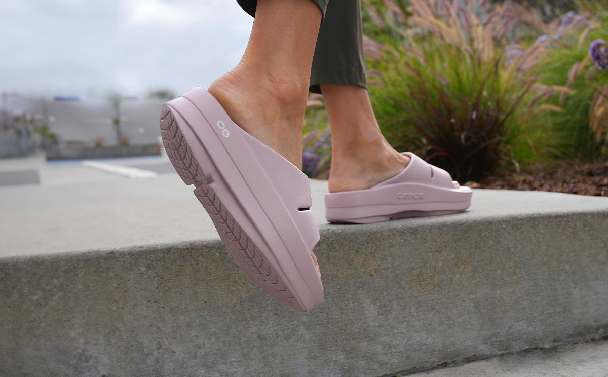 Women's OOmega OOahh Sandal - Stardust model walking on ledge outside | lifestyle