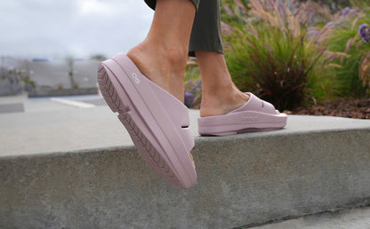 Women's OOmega OOahh Sandal - Stardust model walking on ledge outside | lifestyle