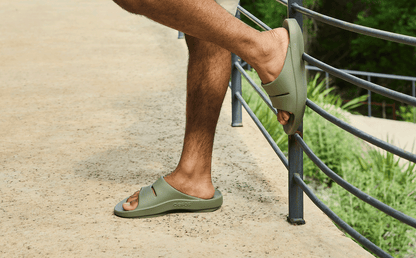 Men's OOahh Slide Sandal - Foliage model posing against fence outside | lifestyle