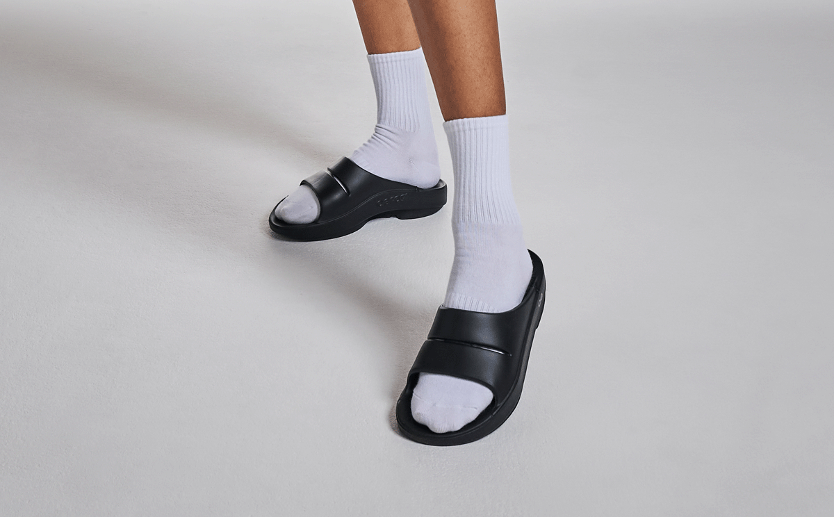 Women's OOahh Slide Sandal - Black model posing in studio | lifestyle