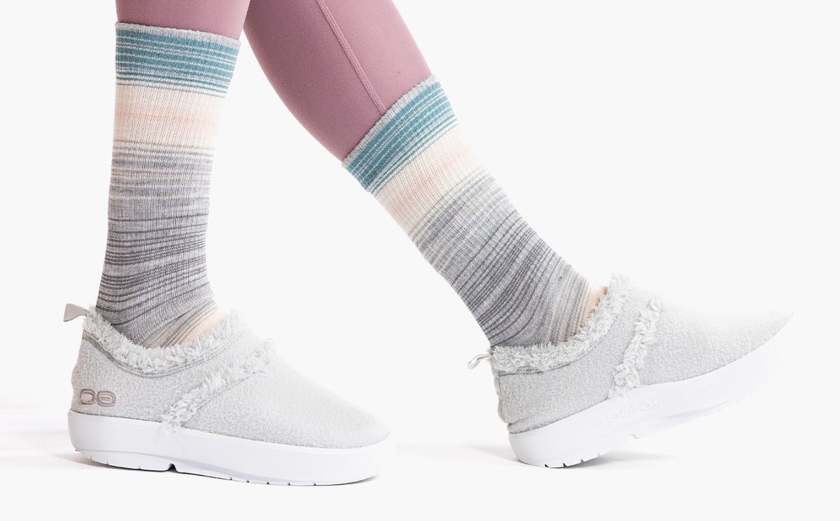 Women's OOcoozie Low Shoe -  Light Gray close up of shoes on model in studio