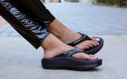 Women's OOmega OOlala Sandal - Black close up of shoes on model 