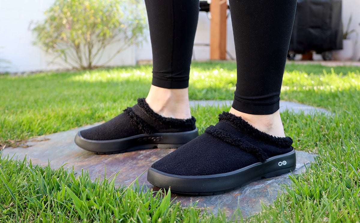 Women's OOcoozie Mule Shoe - Black model in shoe on grass